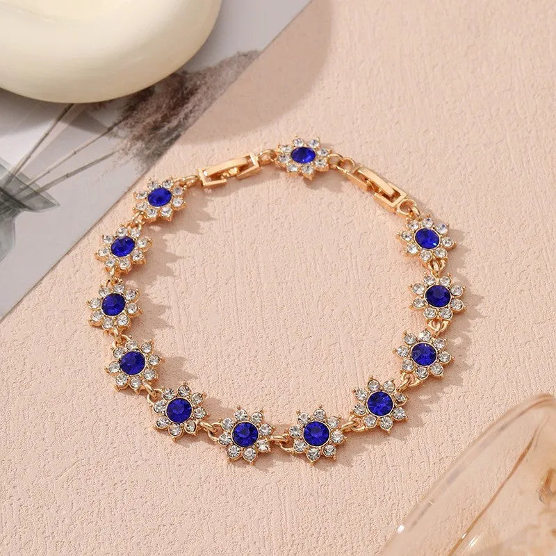 Luxury style bracelet with coloured gems and floral design on zinc alloy with electroplated finish
