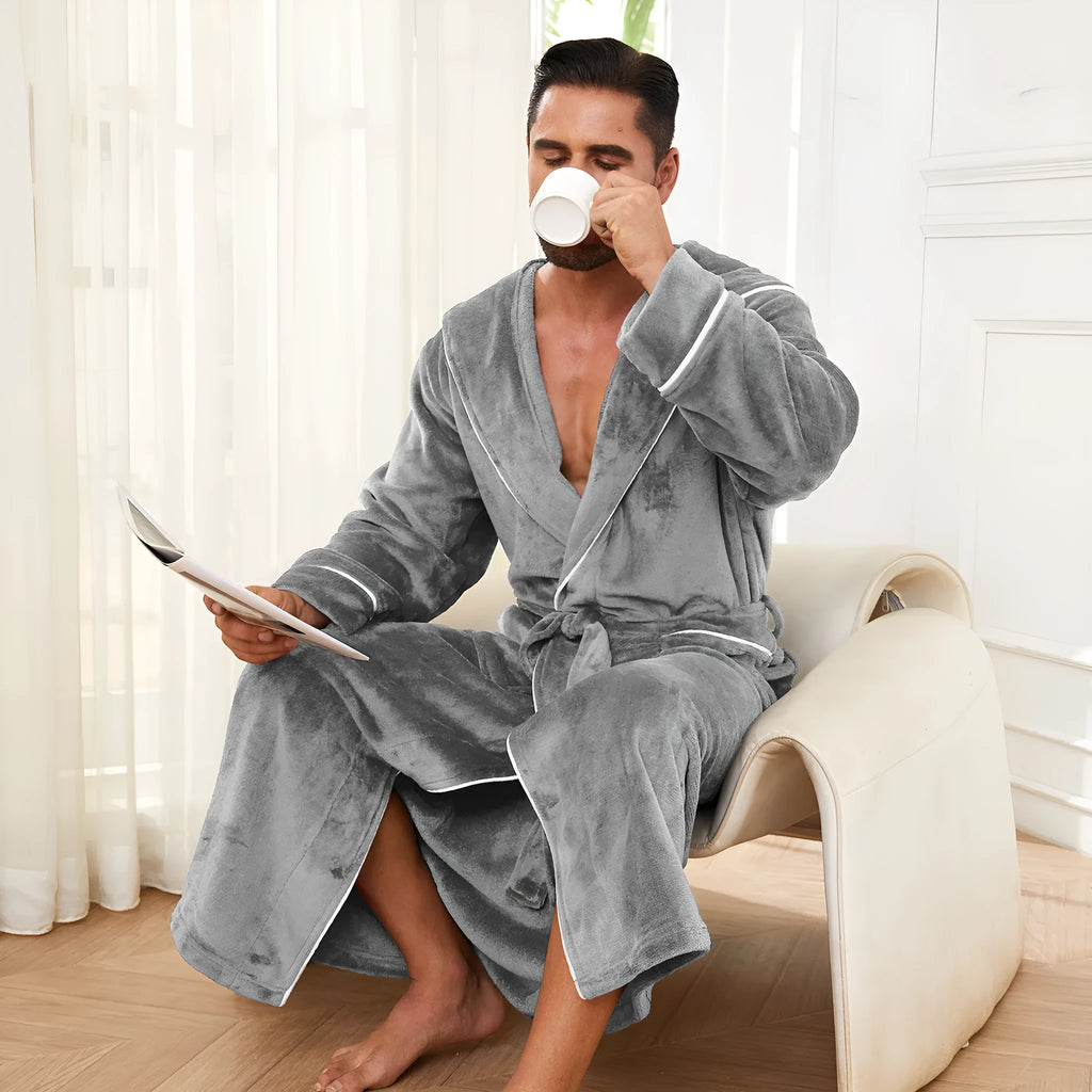 Man wearing a light grey flannel-style bathrobe at home, showing the front wrap design and soft texture.