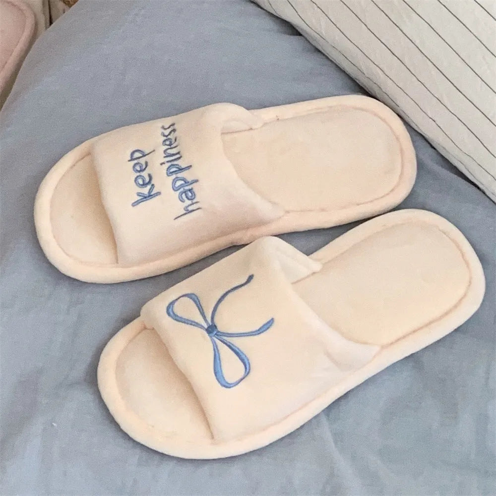 Ladies cotton slippers with suede upper, artificial wool lining, flat non-slip PVC sole, bow and letter detail, beige yellow pink black