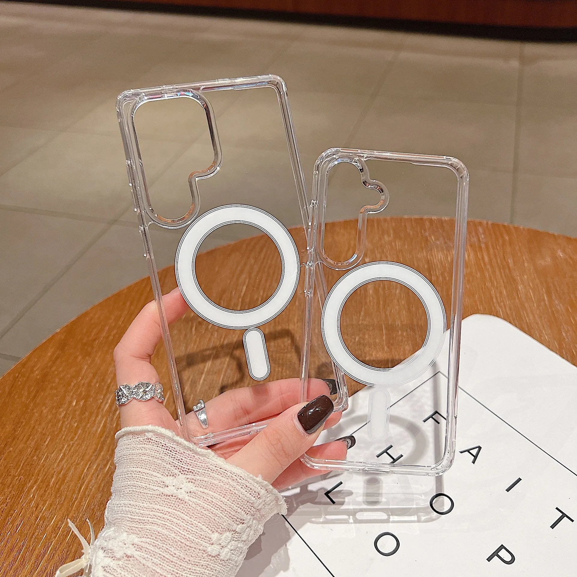 Transparent magnetic silicone phone case for Samsung Galaxy smartphones on a flat surface.