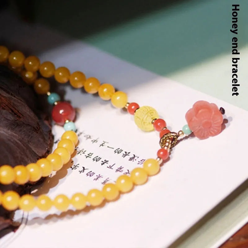 Amber bracelet with carved chicken zodiac charm and 5mm round fantasy crystal elements in retro style