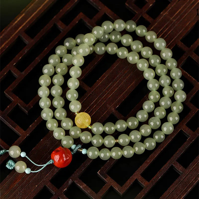Pale blue Hetian Jade bracelet with 6mm beads arranged in three-circle pattern on elastic string