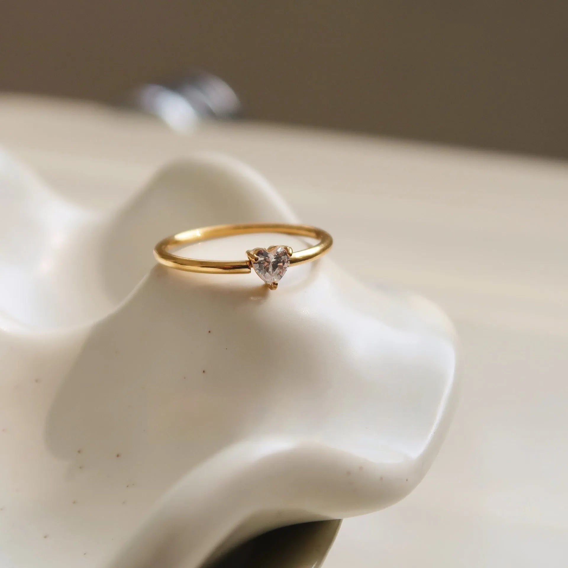 Golden heart-shaped stainless steel ring with electroplated finish available in two colour variations