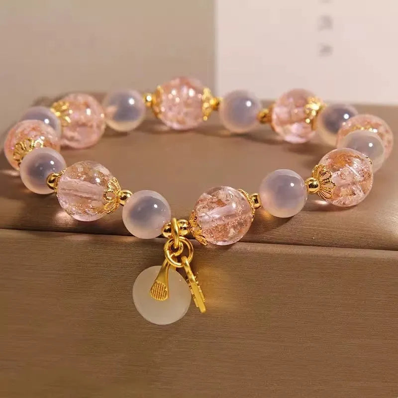 Women's pink heart agate bracelet with peace buckle closure and luminous glaze details
