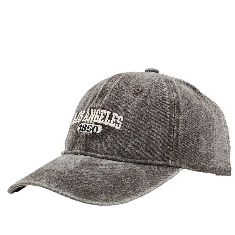 Retro distressed acrylic cap with embroidered letters, shown in beige colour with adjustable strap.