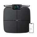 Black eight-electrode intelligent body fat weighing scale on a bathroom floor.