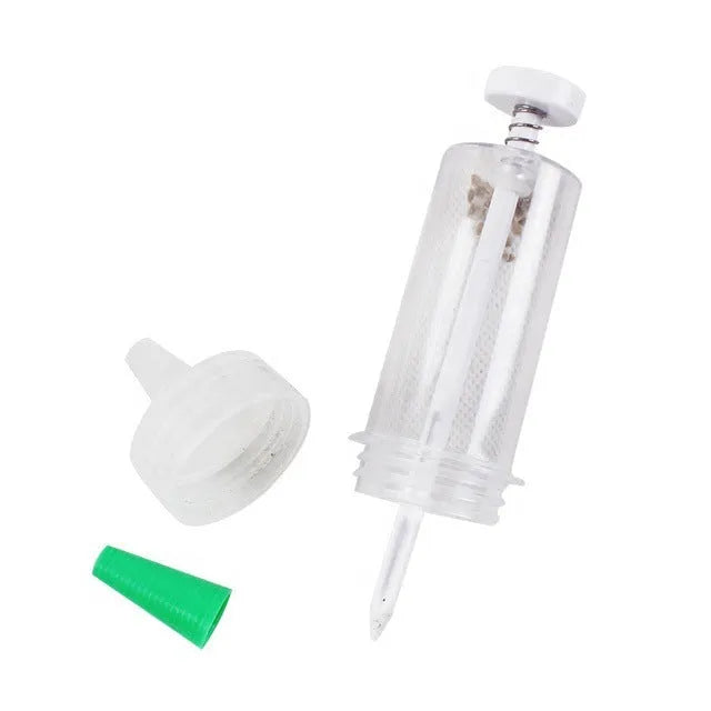 Green plastic mini garden seeder tool with adjustable thumb button, 12cm length