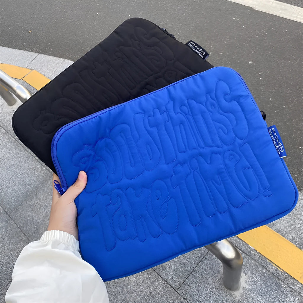 Embroidered blue silk laptop liner bag with letter pattern and cotton lining on a white background