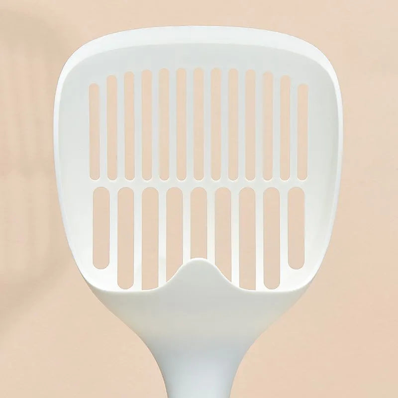 White plastic cat litter scoop sitting in its matching storage base.