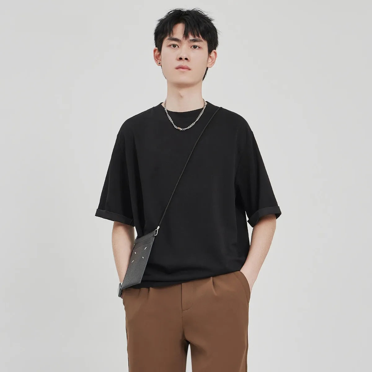 Men's loose fit drape knit T-shirt in polyester blend available in black, brown and white colours