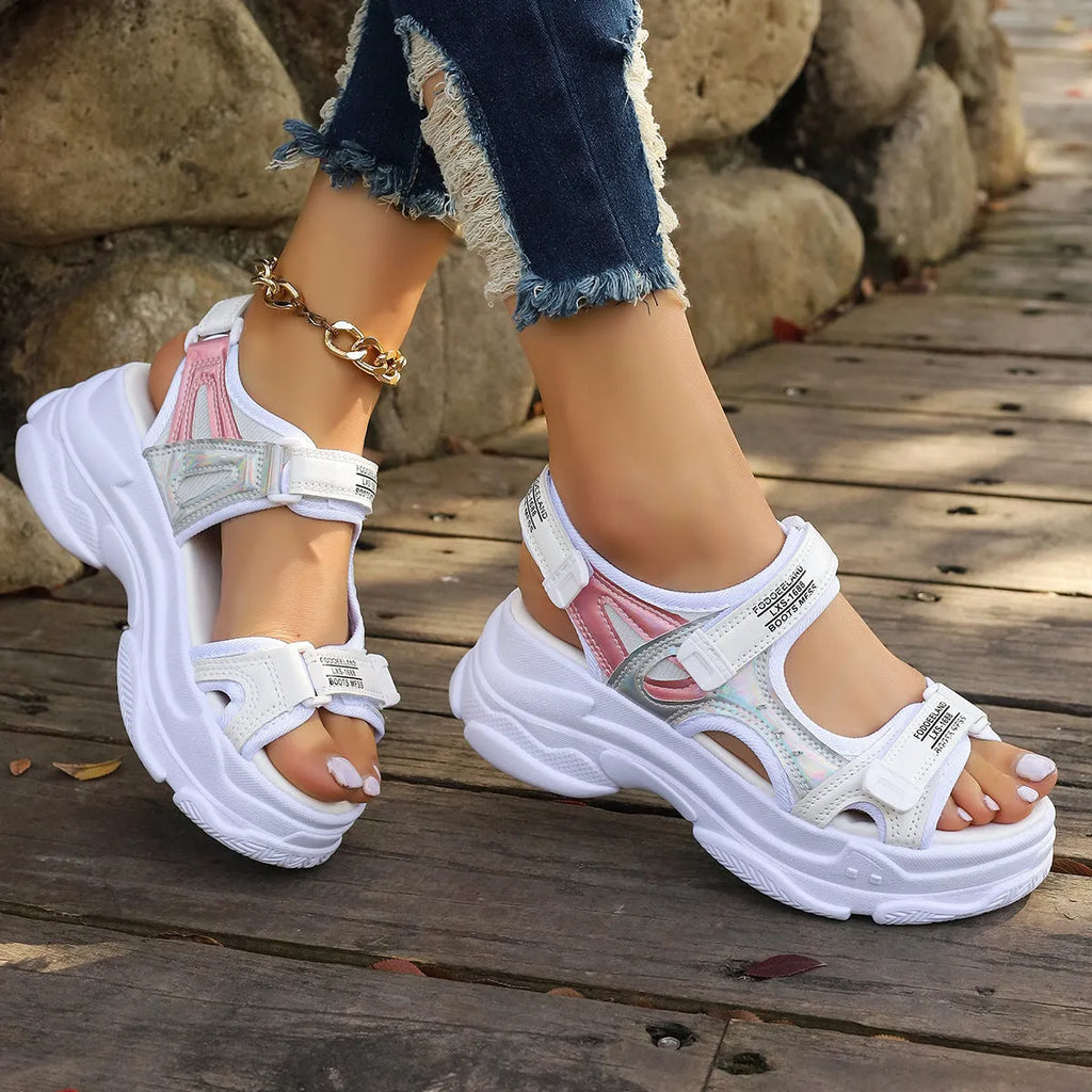 Women's white Roman platform sandals with strap design and rubber sole on a neutral background.