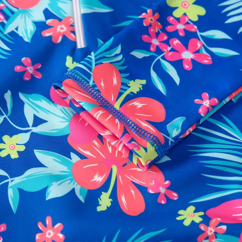 Girl's long-sleeve one-piece swimming suit in a bright colour, showing the full briefs-style design.