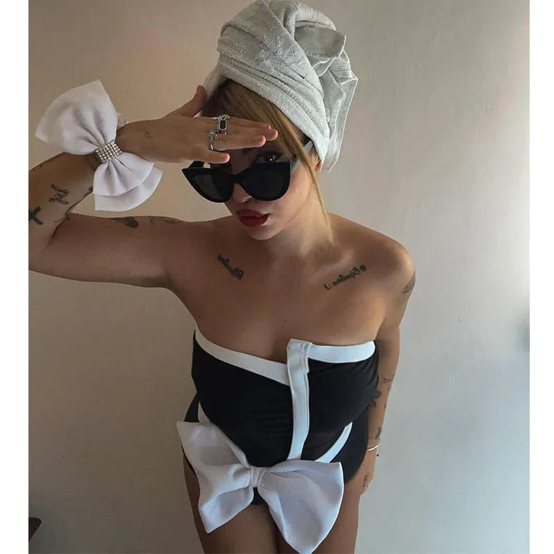 Women's black and white colour-block one-piece swimsuit with asymmetric bow detail