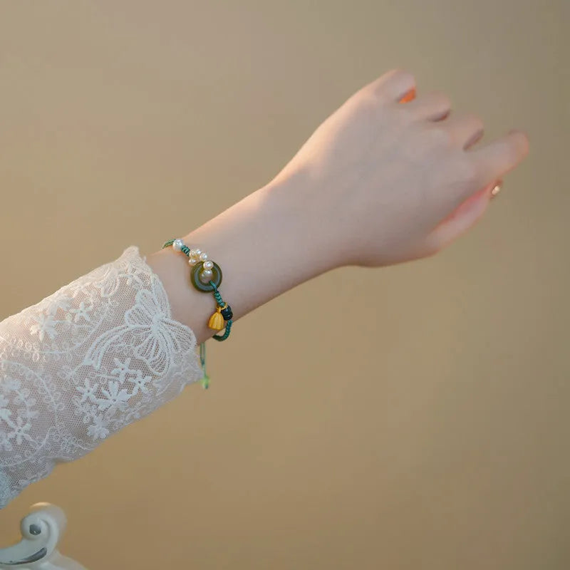 Hand-woven round watch band made from flexible wire with a Pearl Peace Buckle clasp