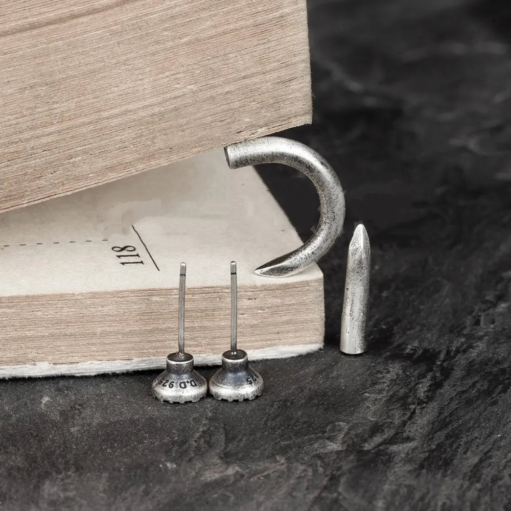 Sterling silver nail-shaped stud earrings with punk retro design