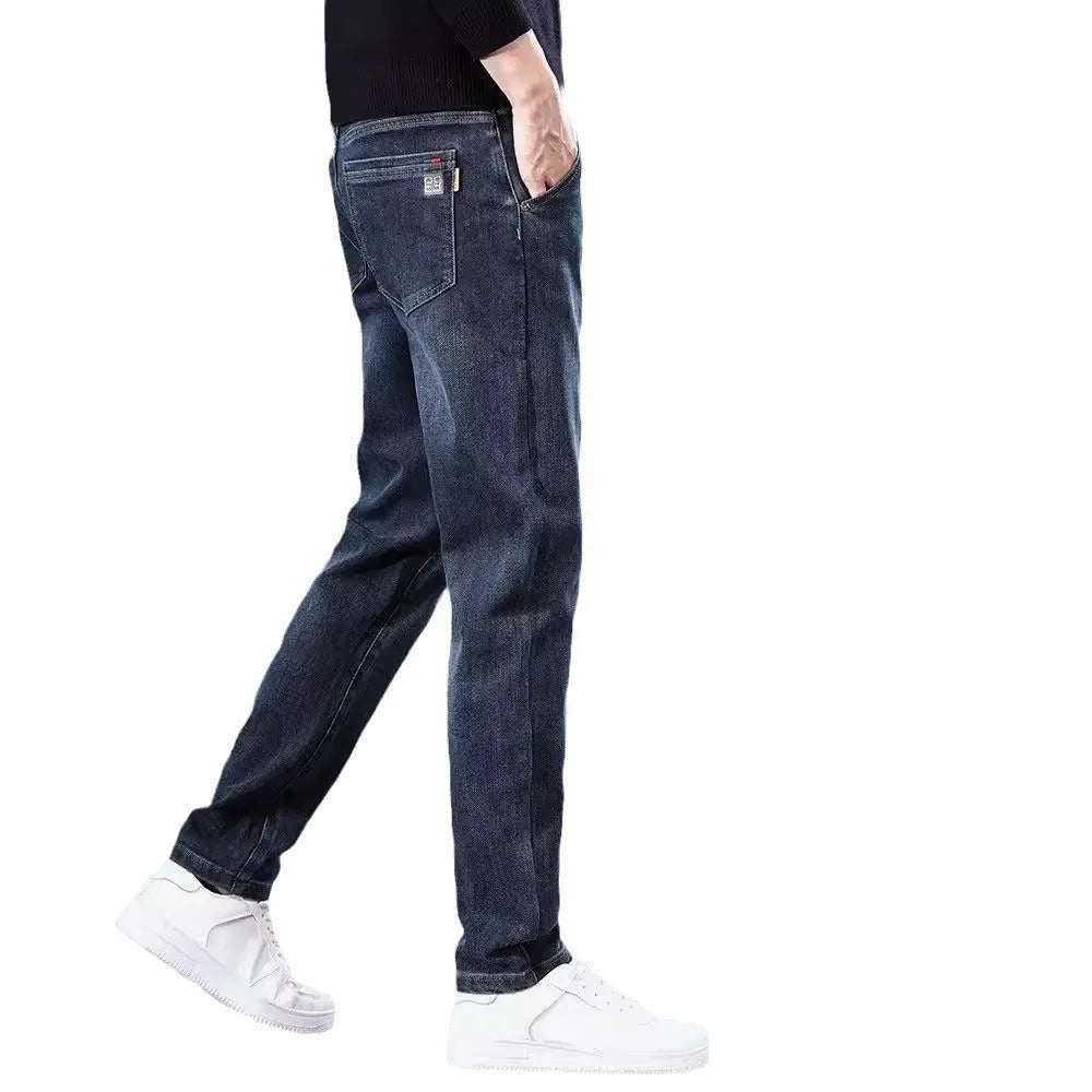 Blue grey men's slim straight casual trousers with a mid waist and zip fly on a neutral background.
