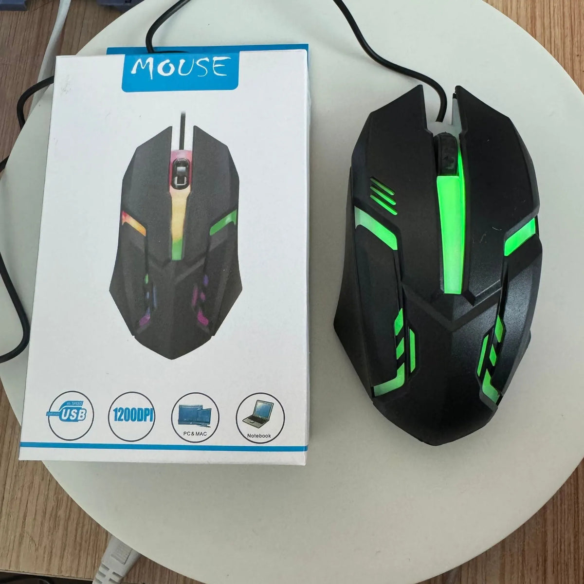 Wired USB photoelectric mouse with 1.35m cable for desktop, shown in black ribbon colour packaging or white