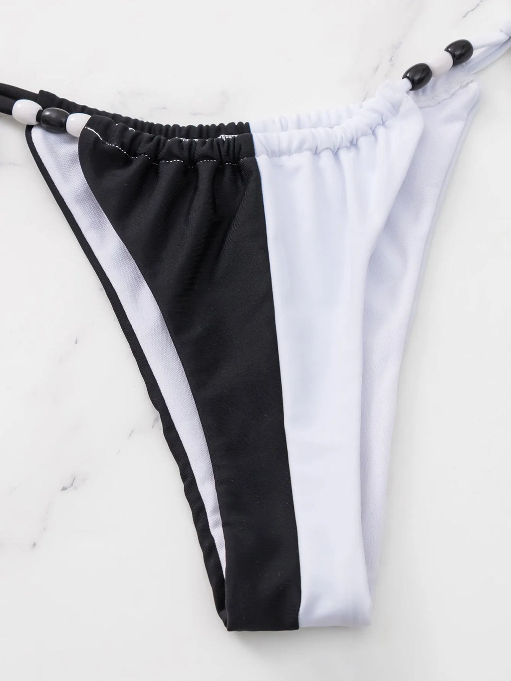 Women's black and white lace-up triangle cup bikini swimsuit set with adjustable ties