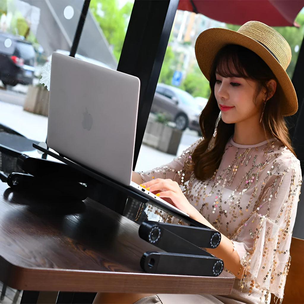 Black folding computer desk with metal frame and cooling fan for laptop use