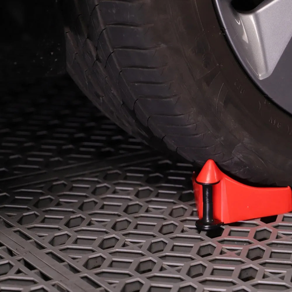 Four red plastic car stop parking blocks with non-slip rubber tread surfaces for tyre guidance