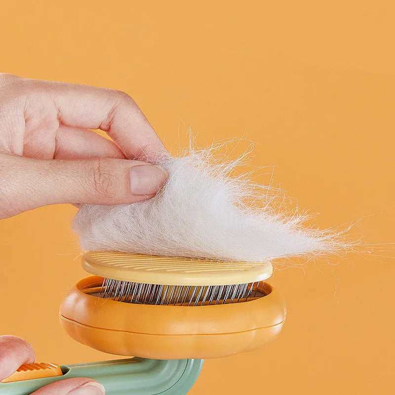 Hand-held pet grooming brush with stainless steel needles in pumpkin colour design