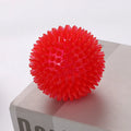 TPR spiky ball squeaker dog toy in red with textured surface for chewing and fetch games