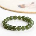 Hand-polished Hetian jade ball bracelet on wrist, showing deep water clear beads.
