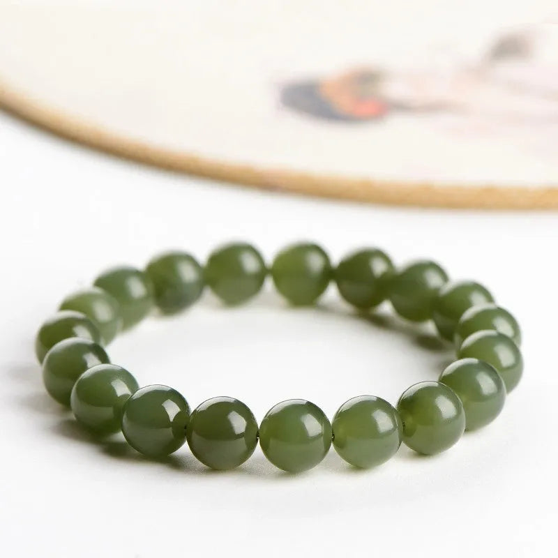 Hand-polished Hetian jade ball bracelet on wrist, showing deep water clear beads.