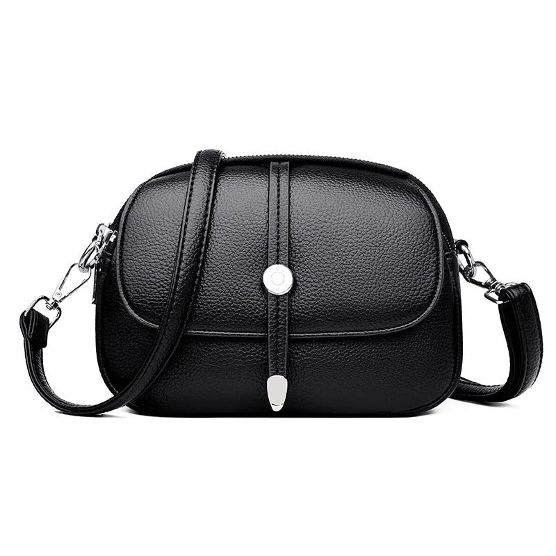 Women's crossbody shoulder bag in oval suitcase shape with soft PU construction