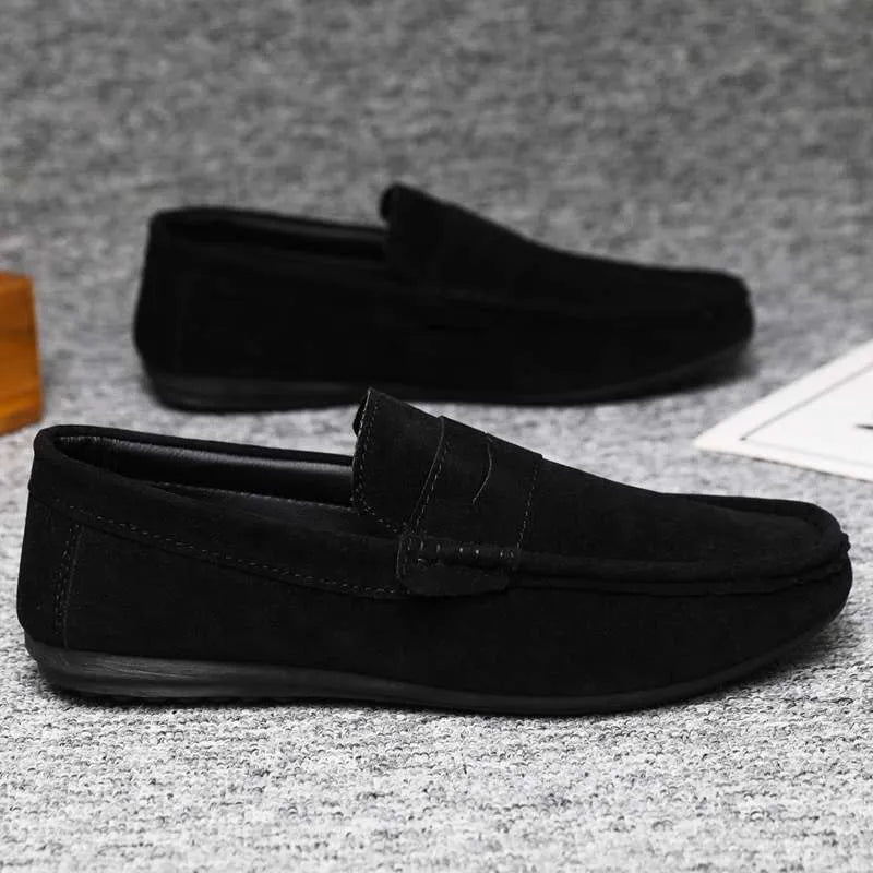 Men's black Gommino style slip-on loafers with round toe and textured rubber sole.