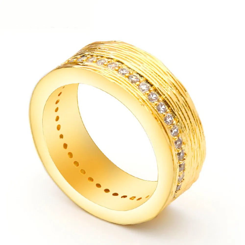 Gold coloured geometric zircon ring for women on a plain background.