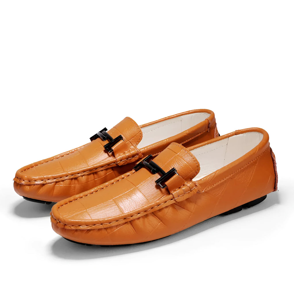 Men's black leather casual shoes with a silver belt buckle and flat rubber sole.