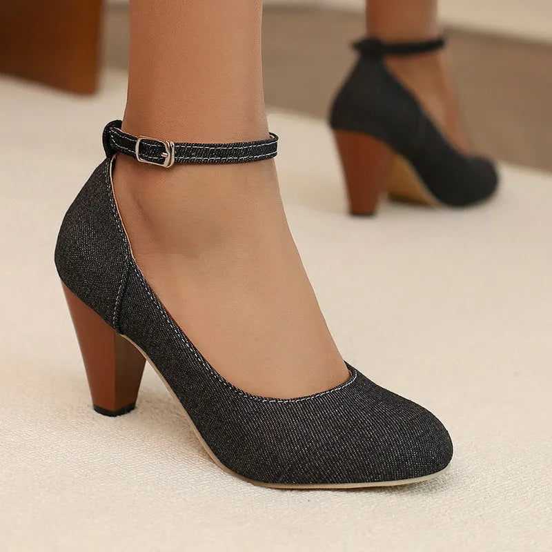 Women's blue denim platform high heels with an ankle buckle and a thick rubber sole.