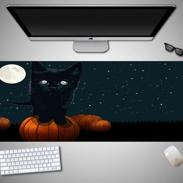 Oversized Halloween gaming mouse pad with non-slip rubber base on a desk