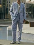 Blue and white striped women's blazer and trouser suit set on a hanger
