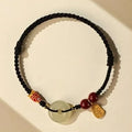 Handmade bracelet with jade peace buckle on black, colourful, or red braided rope.