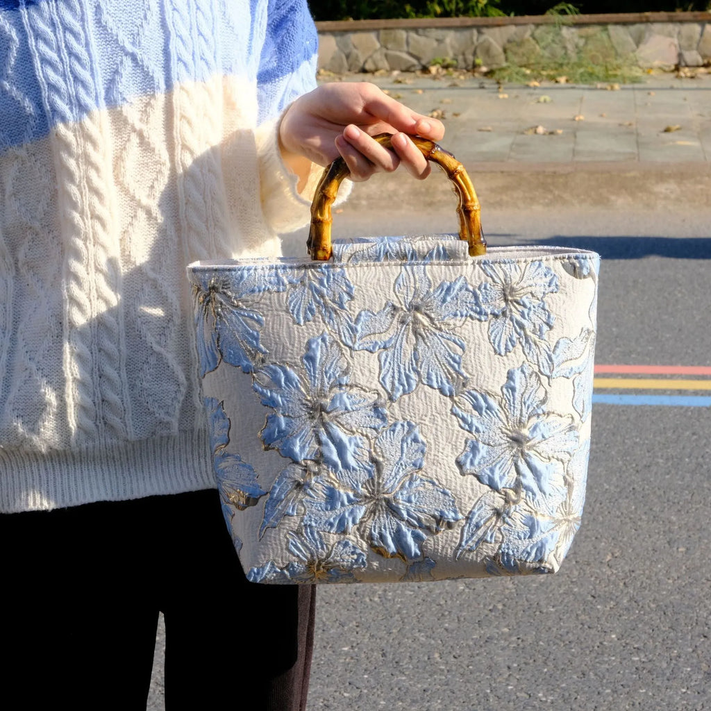 Light blue square canvas shoulder bag with gold bronzing flower pattern and double straps