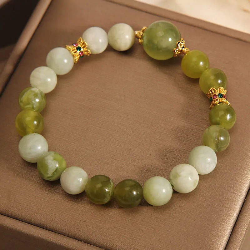 Women's bracelet made of green Xiuyan jade with an original design on a wrist.