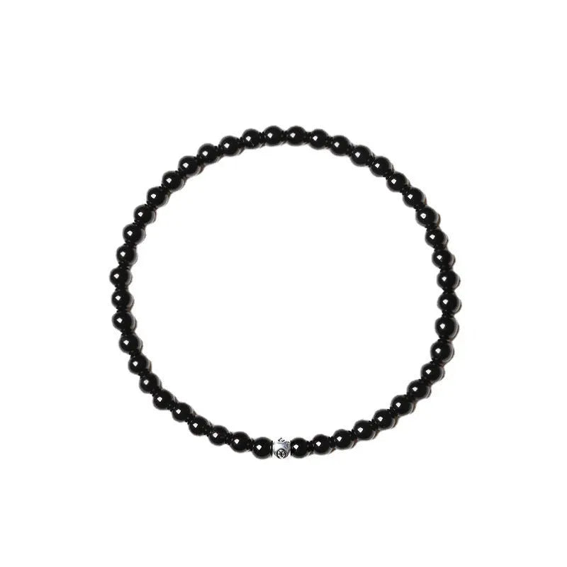 Simple geometric agate bracelet with round and square 4mm beads on a wrist.