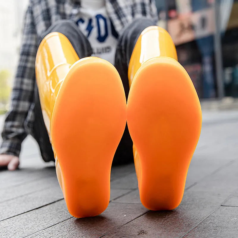 Men's white plastic high tube rain boots with a flat heel on a solid background.