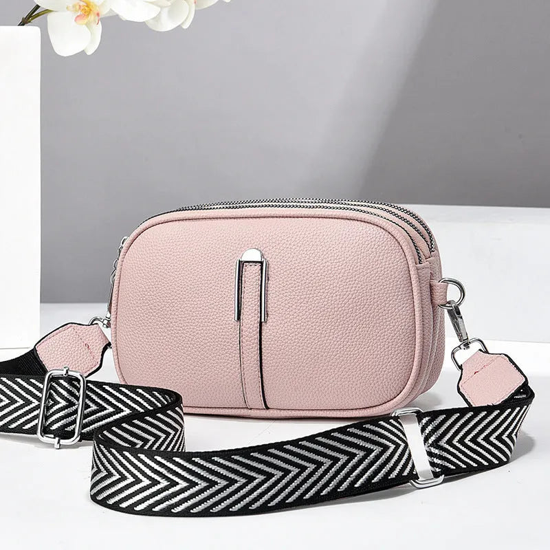 Soft oval PU leather crossbody handbag with stone pattern and internal organiser compartments.