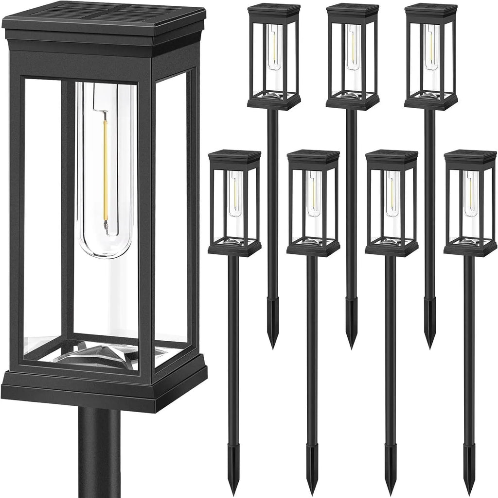 Round tungsten wire solar lawn lamp on grass in a garden courtyard emitting warm light