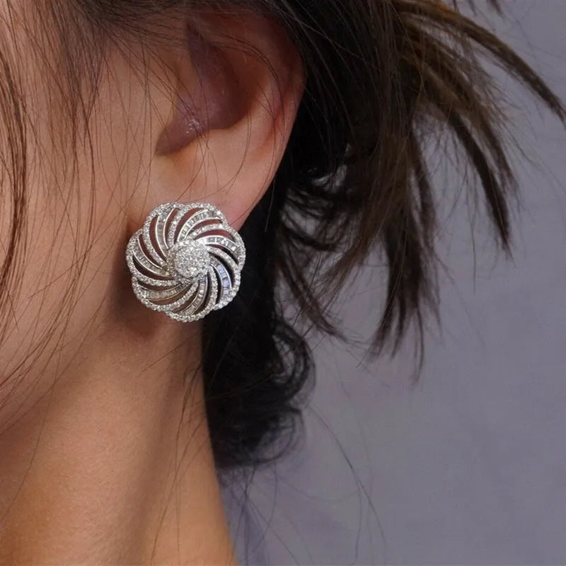 Copper geometric line flower design earrings with inlaid zircon in white gold colour on a neutral background