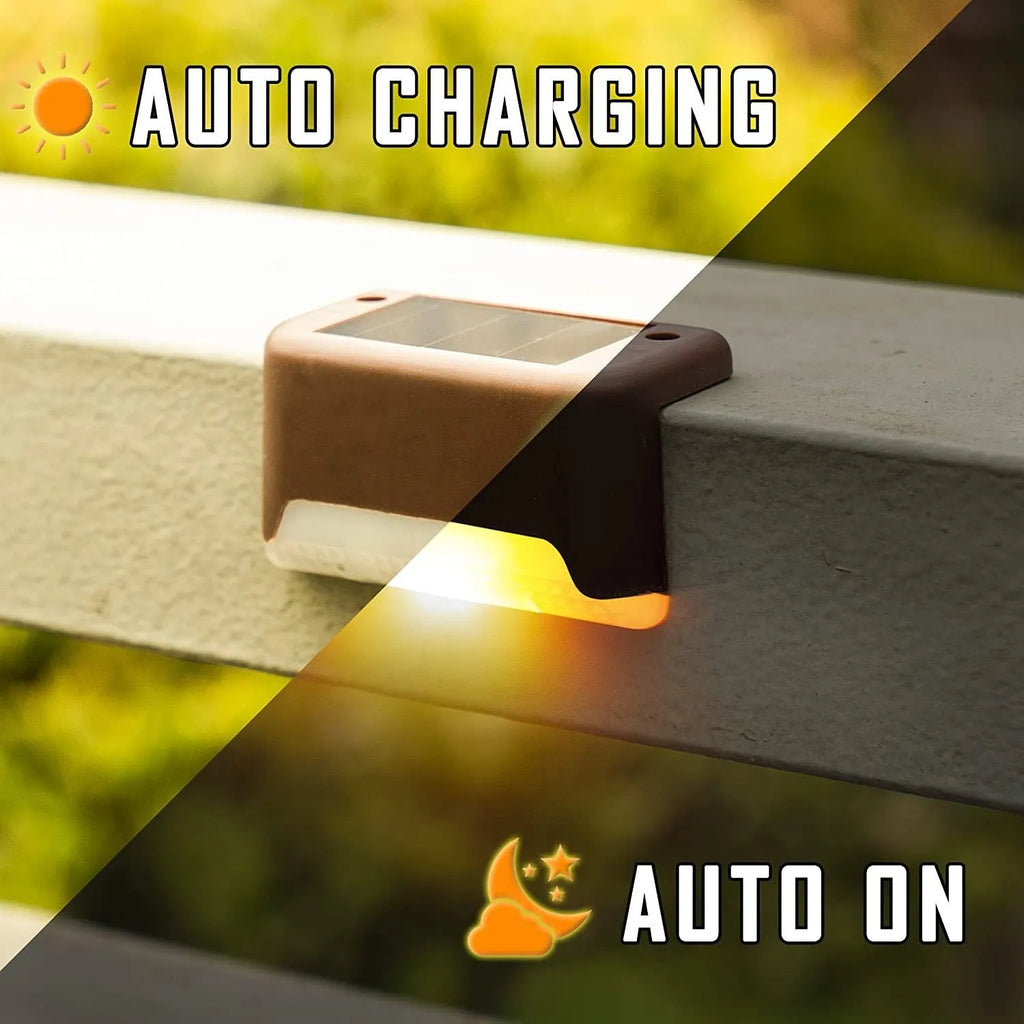 Set of four brown solar step lights with warm LED glow mounted on outdoor wooden stairs