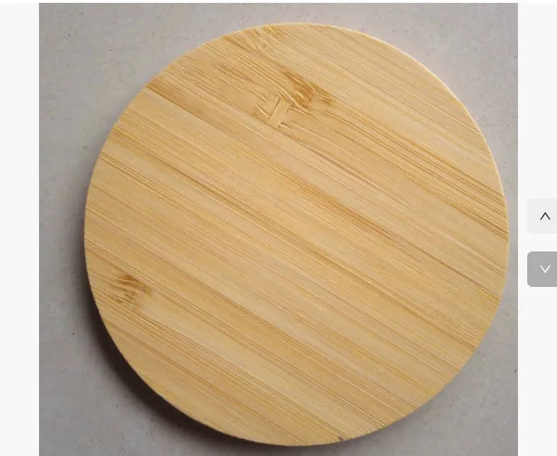 Brown heart-shaped wooden bamboo 5W Qi wireless charging pad on a desk