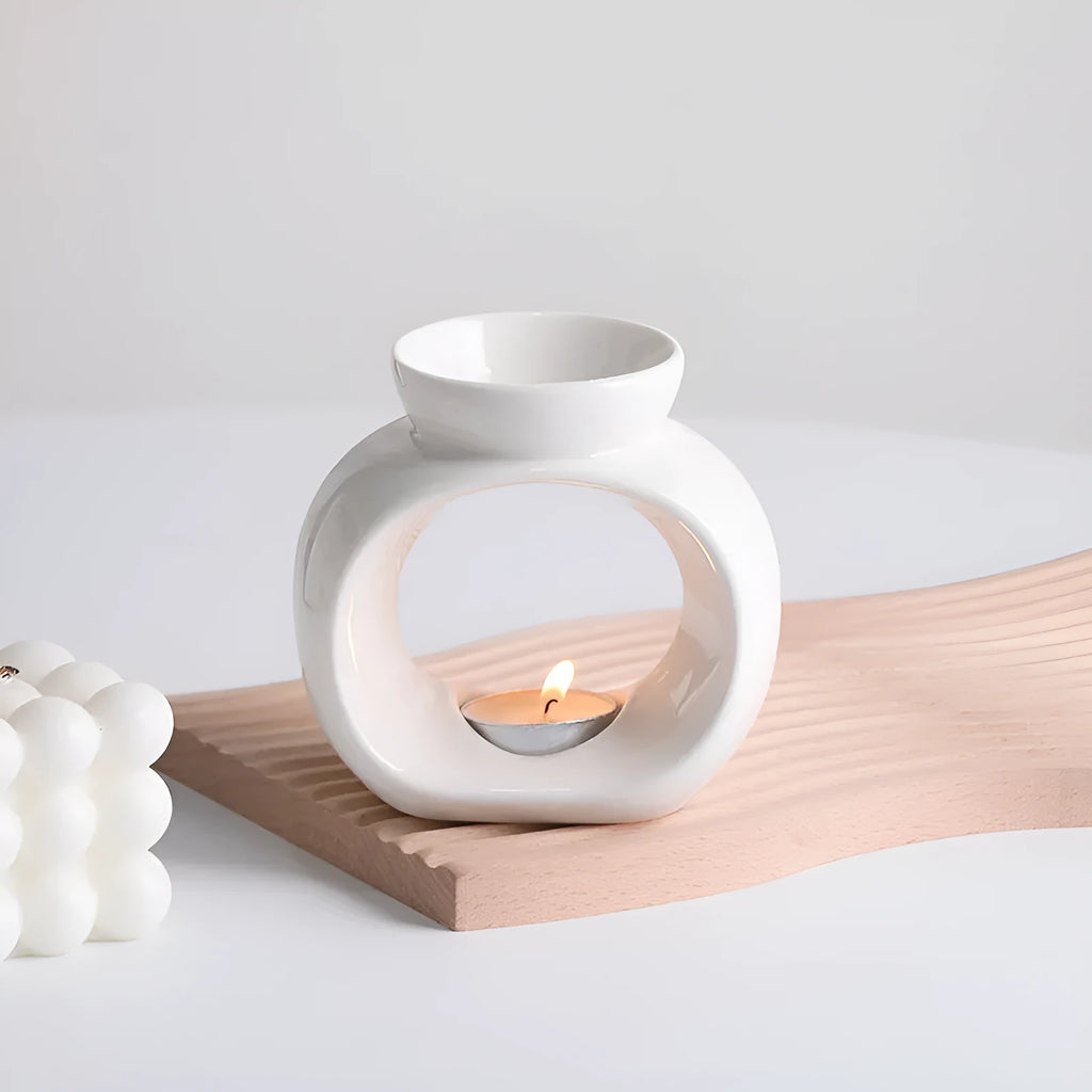 White glazed porcelain Nordic style aromatherapy stove ornament on a table.