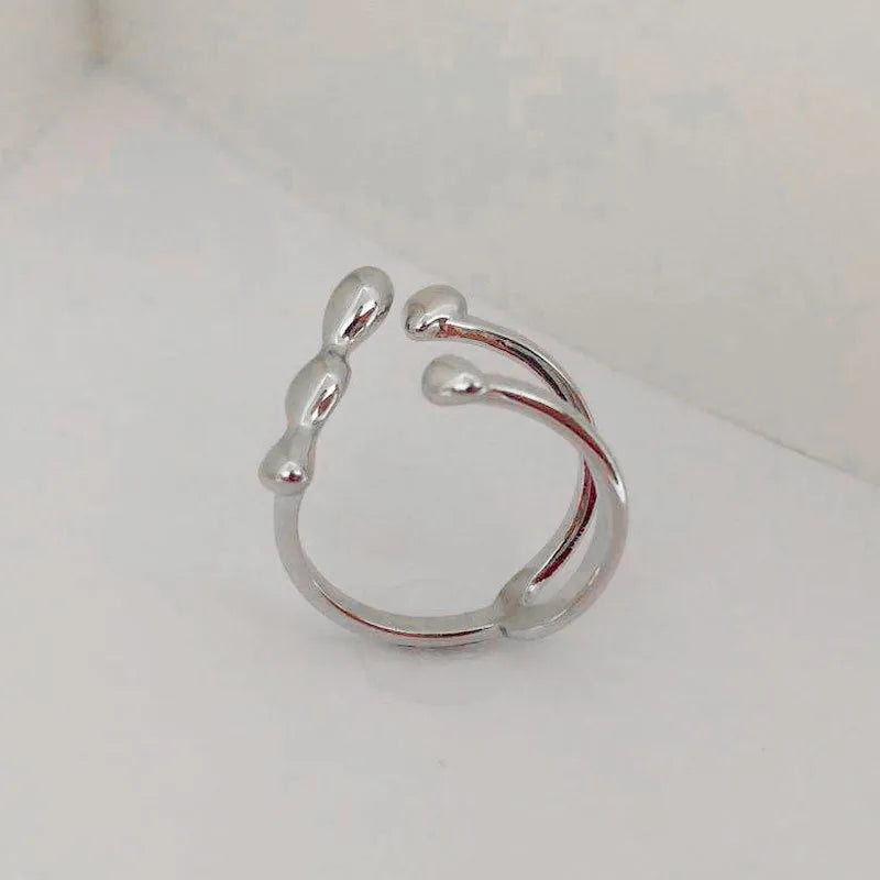 Brass opening ring for women with spherical design in gold or silver finish.