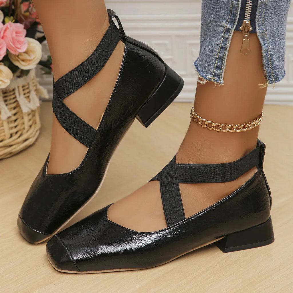 Gold French style slip-on evening pumps with square toe and low heel on a white background