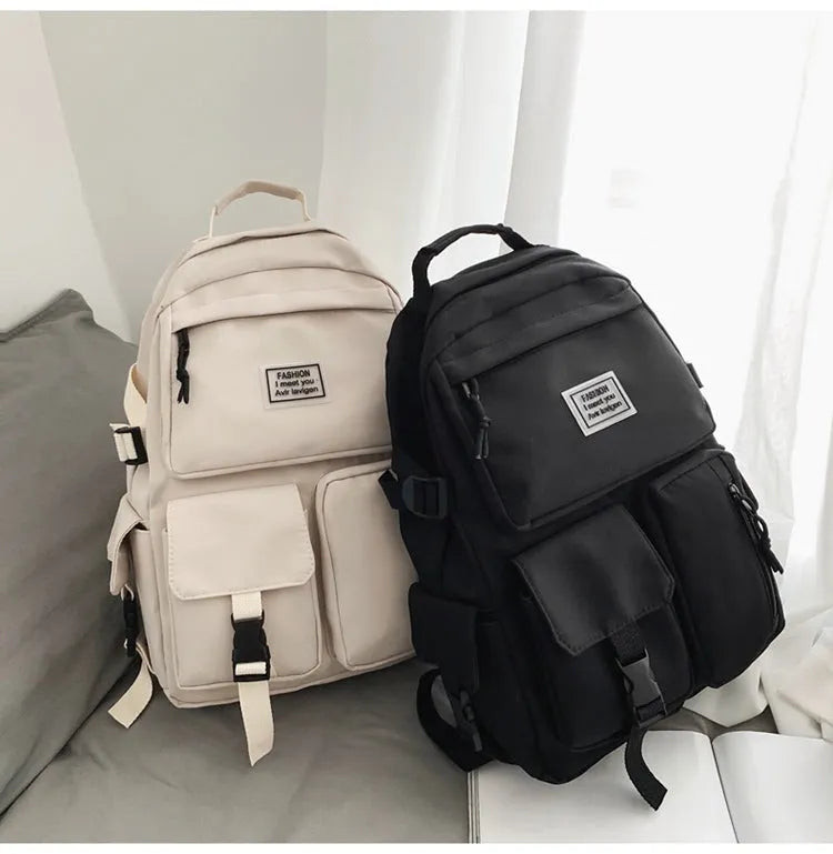 Black or white nylon student backpack with computer compartment measuring 31x12x41cm