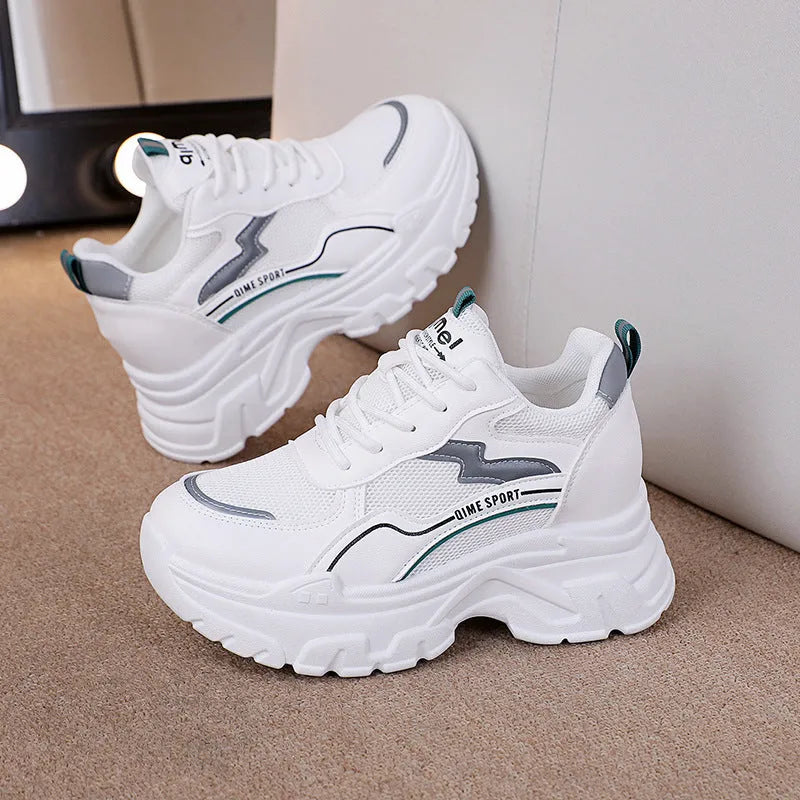 Women's white breathable dad shoes with height increasing insole and lace-up front.